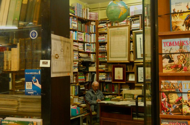 Ozvena editorial workspace in Bratislava with books and celestial maps